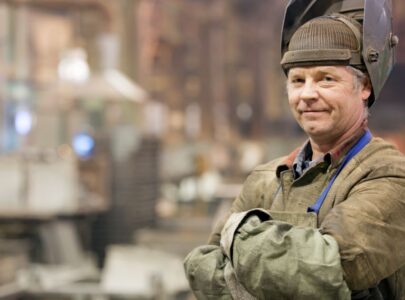 Portrait factory senior welder worker on manufacture workshop background