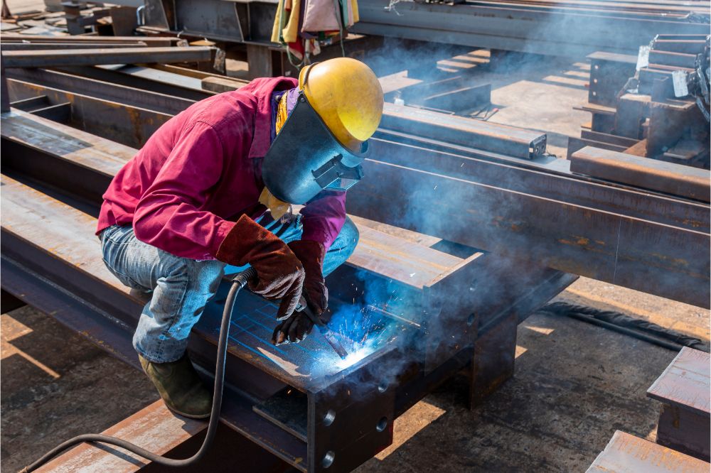 welder is welding a steel structure work with process Flux Cored Arc Welding